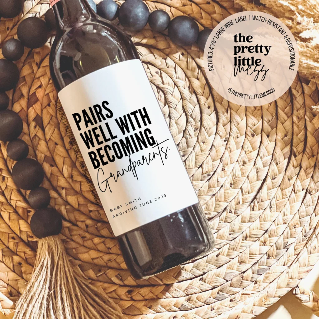 Baby announcement to grandparents custom wine label that says “pairs well with becoming grandparents”.