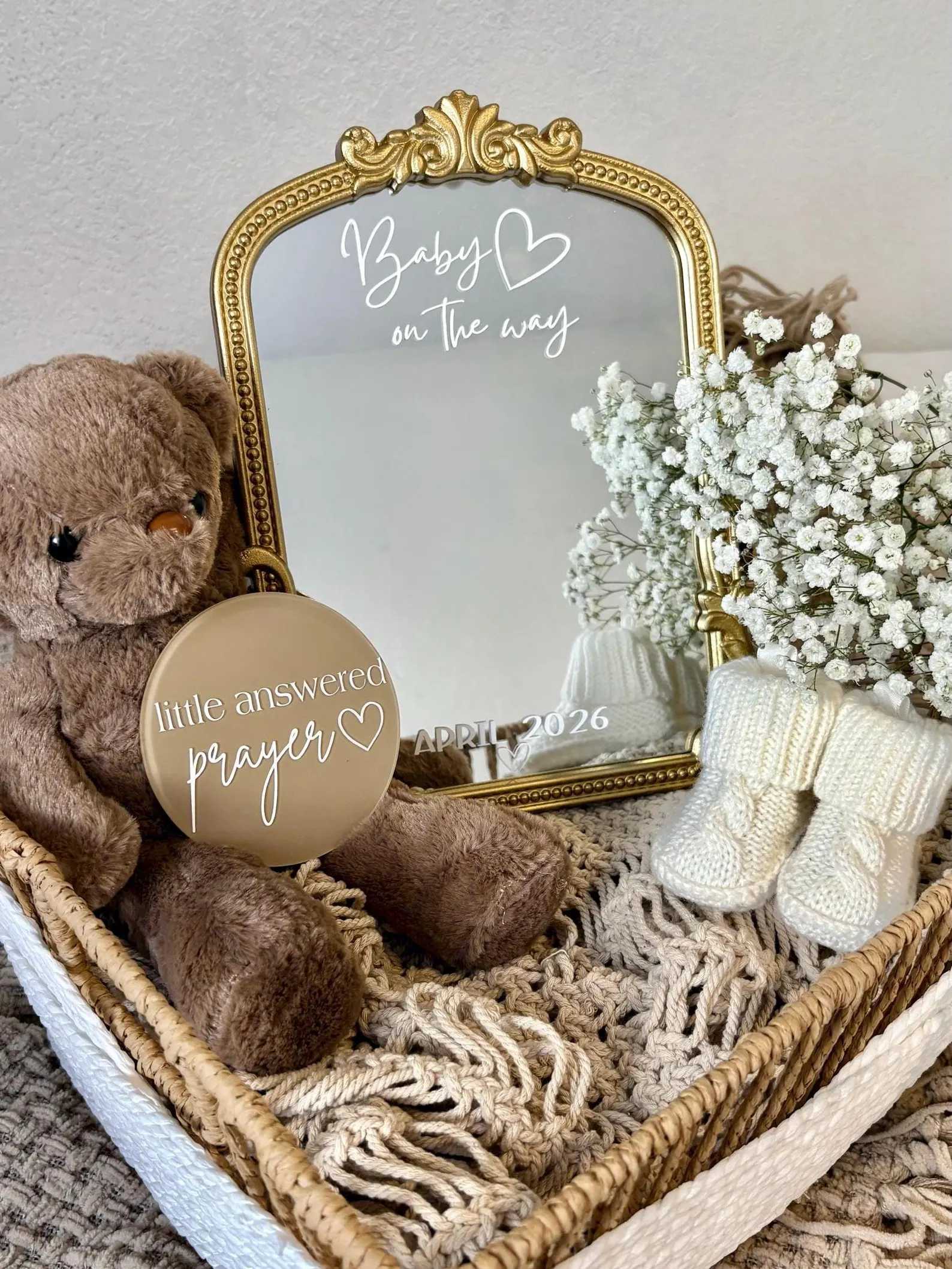 Pregnancy announcement gift box for parents with mirror, flowers, and teddy bear.