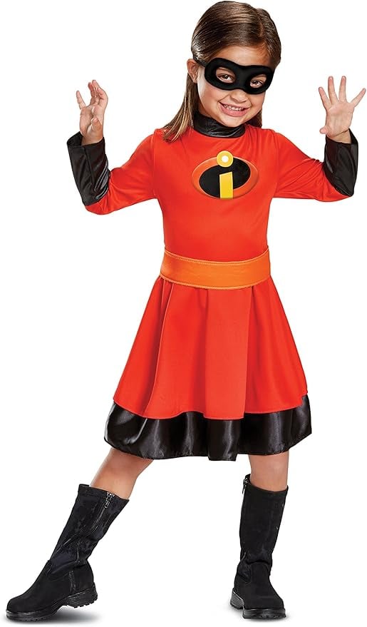 Smiling young girl wearing a Violet Parr costume from The Incredibles, dressed in a red superhero dress with black boots and an eye mask, striking a playful action pose