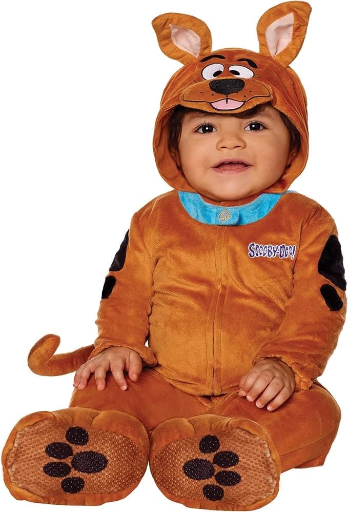 Smiling baby wearing a plush Scooby-Doo Halloween costume with floppy ears, paw-print feet, and a blue collar — perfect for a toddler-friendly group costume