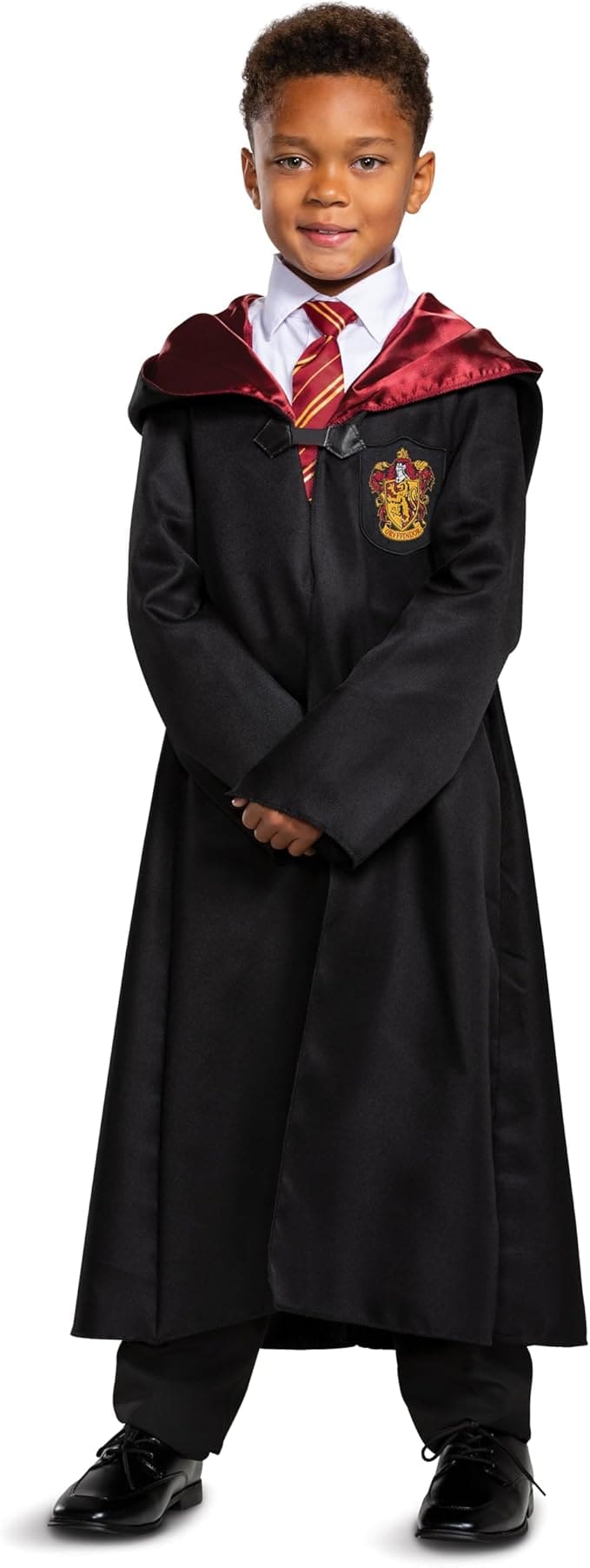 Smiling child wearing a Gryffindor robe costume from Harry Potter with a red and gold tie, white shirt, and black wizard cloak featuring the house crest — perfect for a magical family Halloween theme