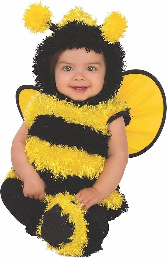 Smiling baby wearing a fluffy yellow and black bumblebee costume with antennae headpiece and matching wings — adorable Halloween outfit for a bee and beekeeper family costume theme
