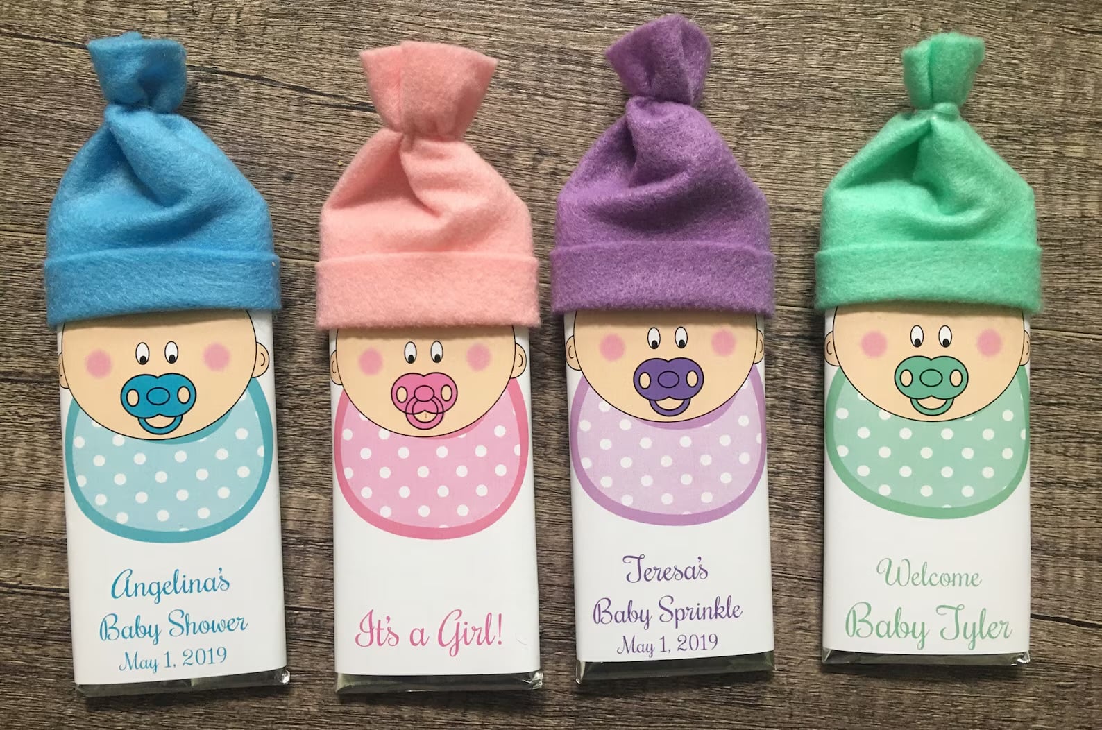 Baby shower party favor candy bars with custom label and felt baby hats.