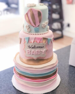 Three tier gender reveal cake