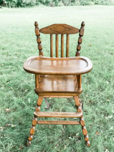 White wooden first birthday high chair
