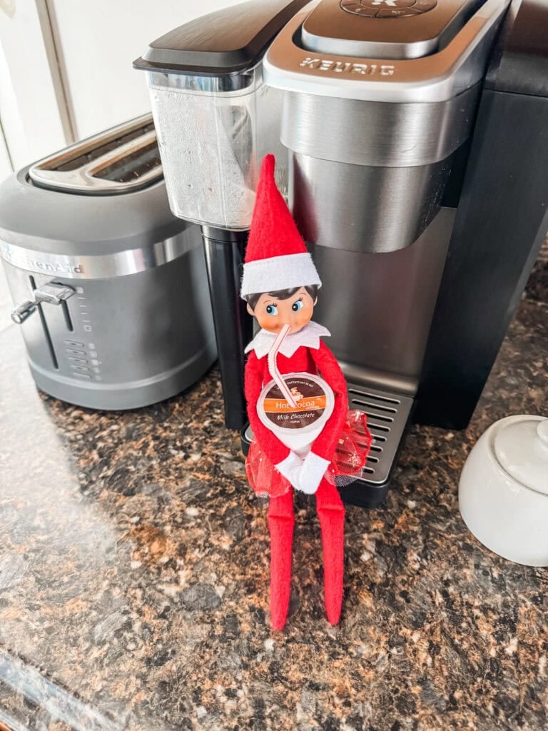 Elf on the shelf drinks from keurig k-cup