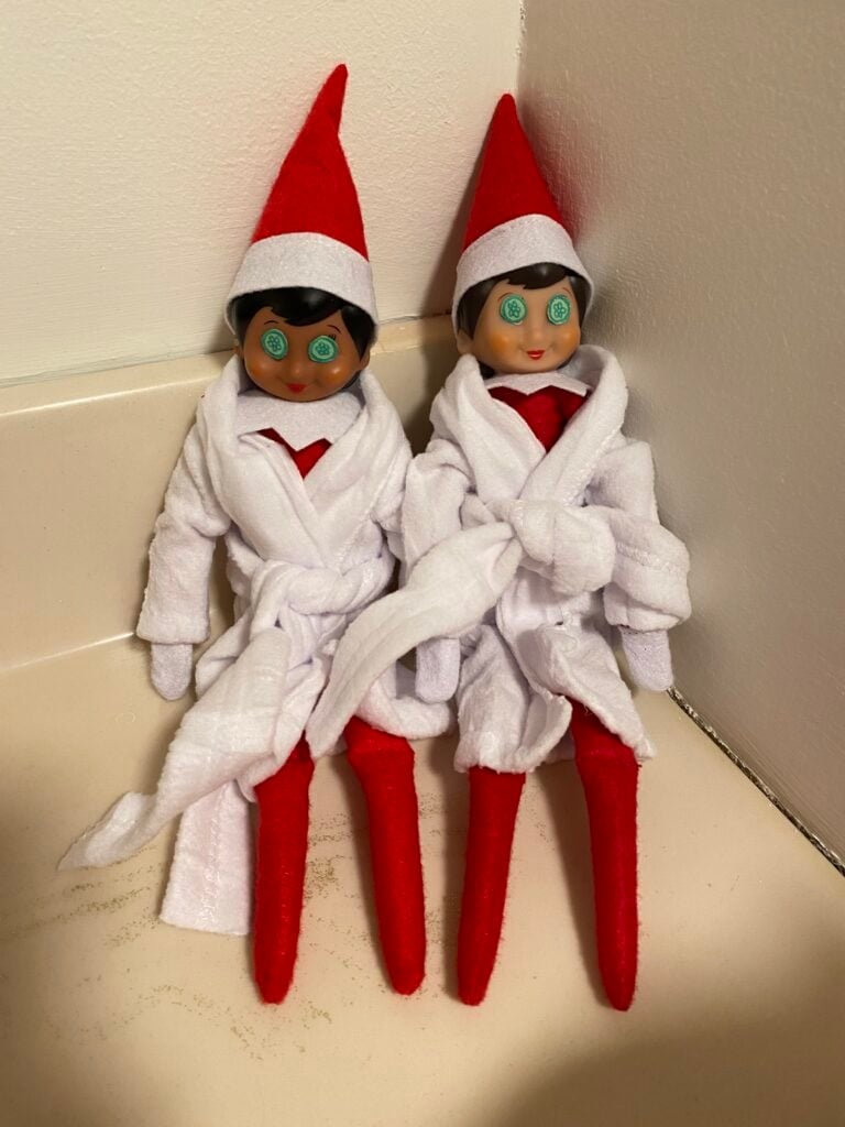Elf on the shelf in robe with cucumbers on eyes