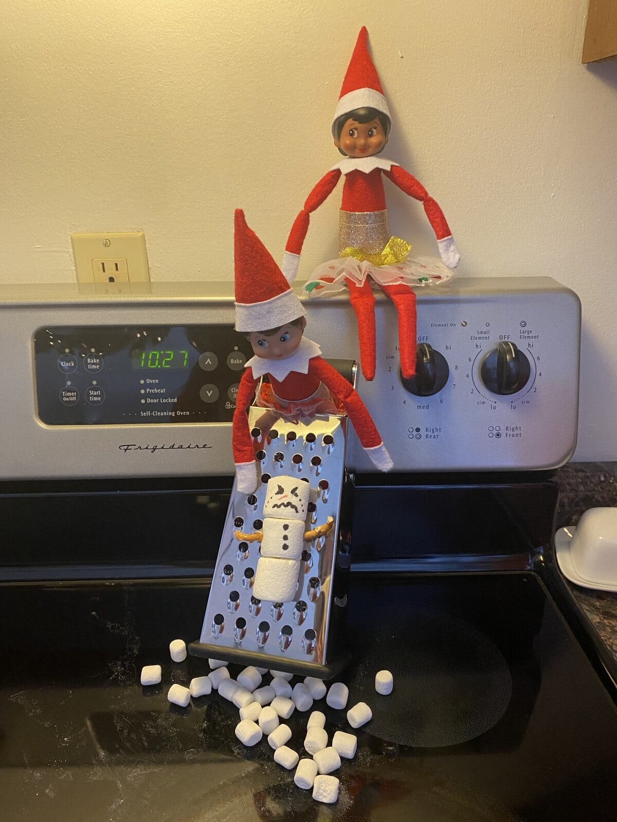 Elf on the shelf uses cheese grater on marshmallow snowman to make mini marshmallows