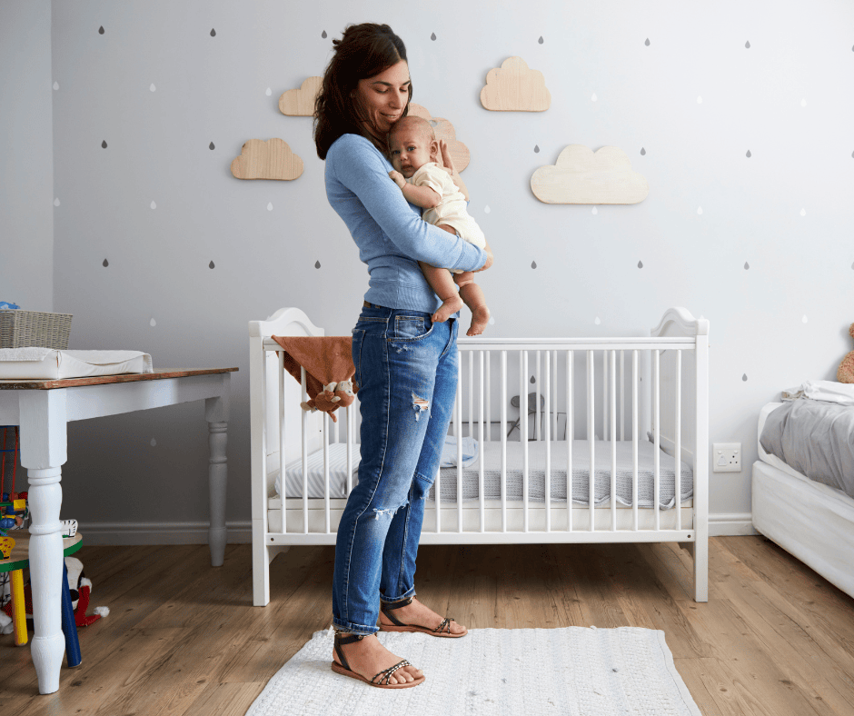 Mother holding baby is nursery.