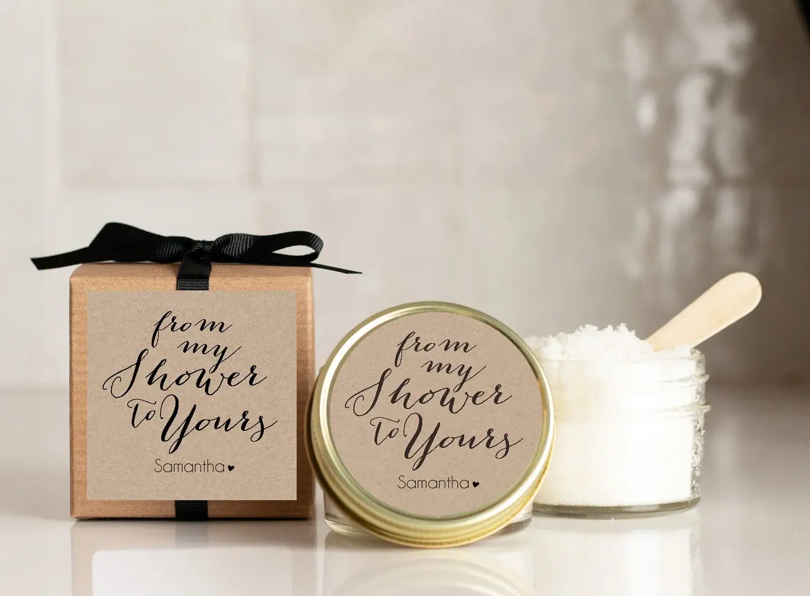 Elegant baby shower favor set featuring a kraft box and matching jar labeled “From my shower to yours” with custom name personalization. Includes a mini jar of bath salts or sugar scrub with a wooden scoop, perfect for spa-themed baby shower guest gifts.