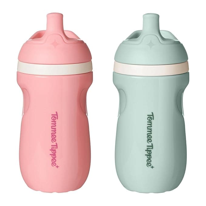 Two Tommee Tippee insulated sippy cups in pastel pink and mint green, designed with leakproof spouts and easy-grip sides for toddlers.