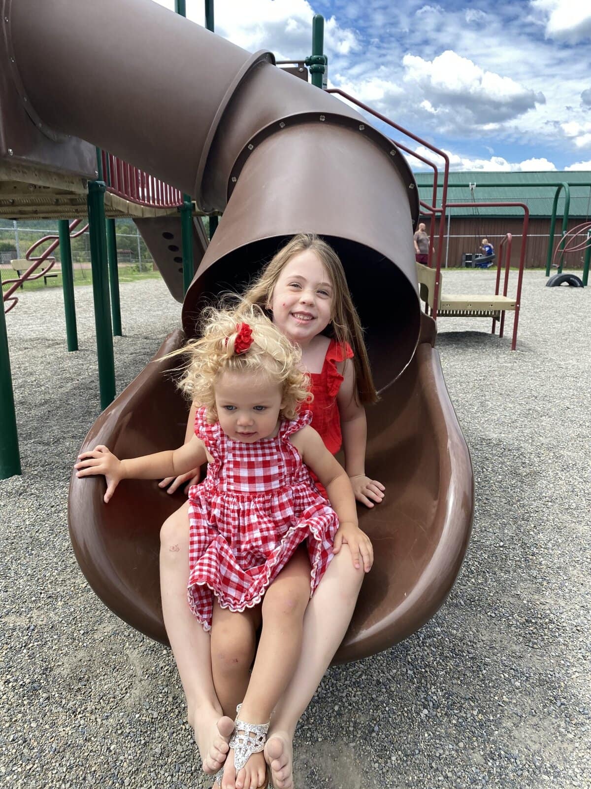 Children climbing and sliding at a sunny outdoor playground