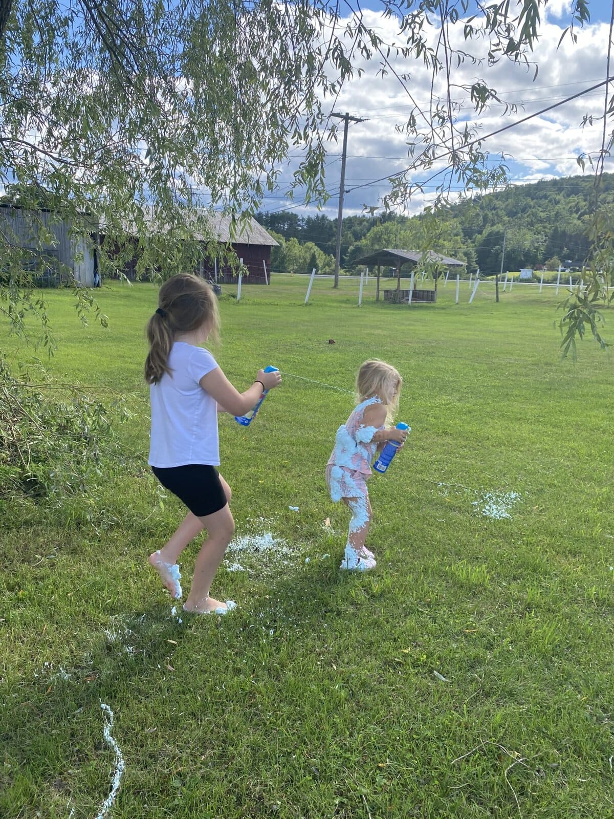 Girls covered in colorful foam during a wild outdoor playtime