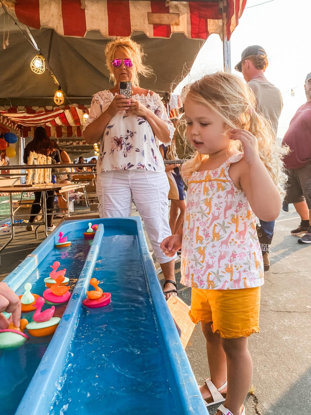 Little girl playing a game at a local fair