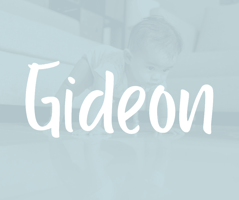 Baby boy crawling on a shiny floor, with the name Gideon written in white over the image.