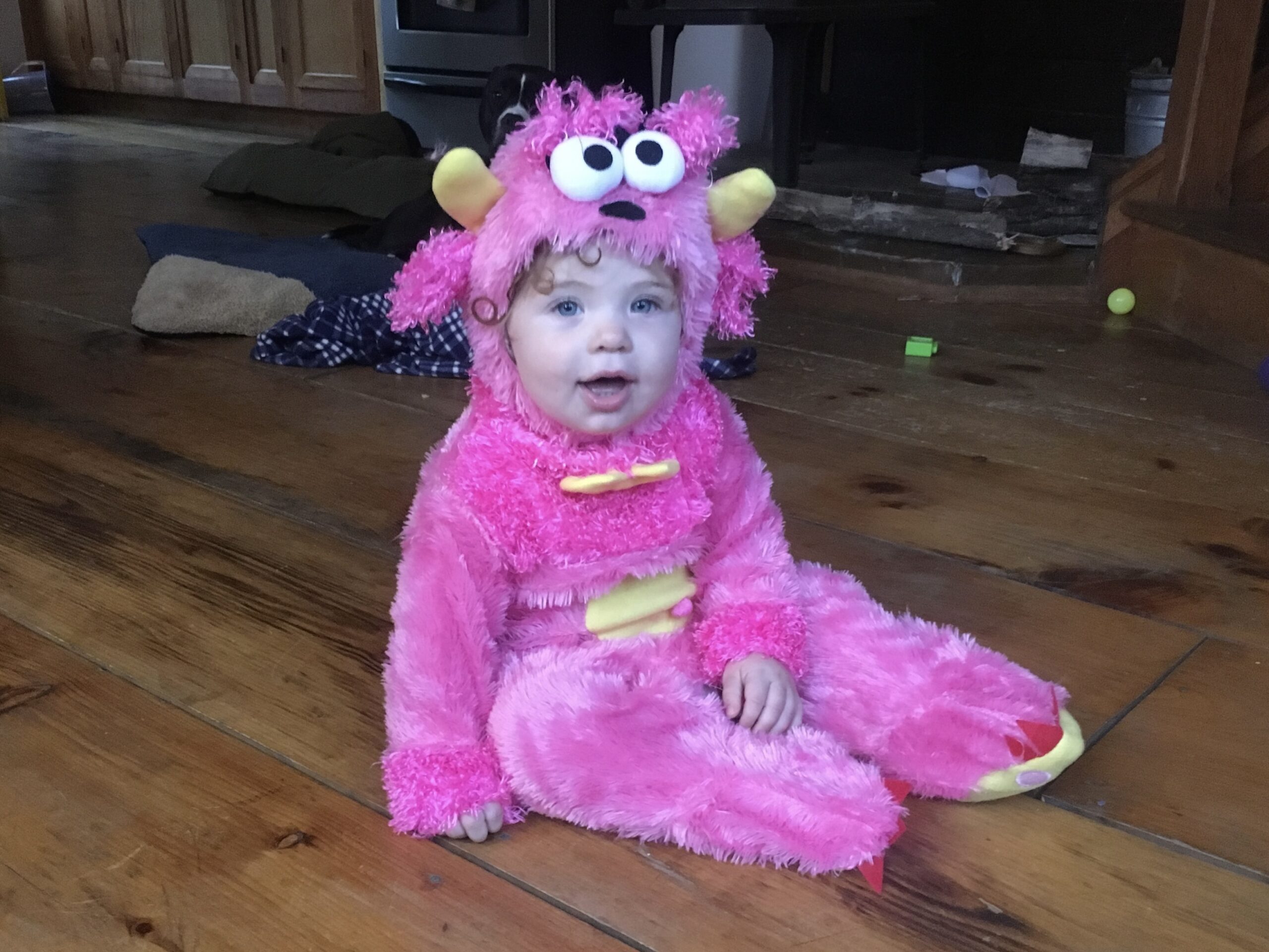 Baby girl in pink monster Halloween costume