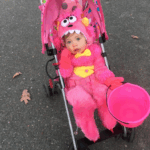 Monster baby girl Halloween costume on girl in stroller