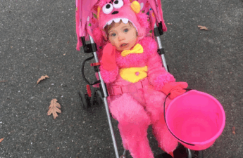 Monster baby girl Halloween costume on girl in stroller