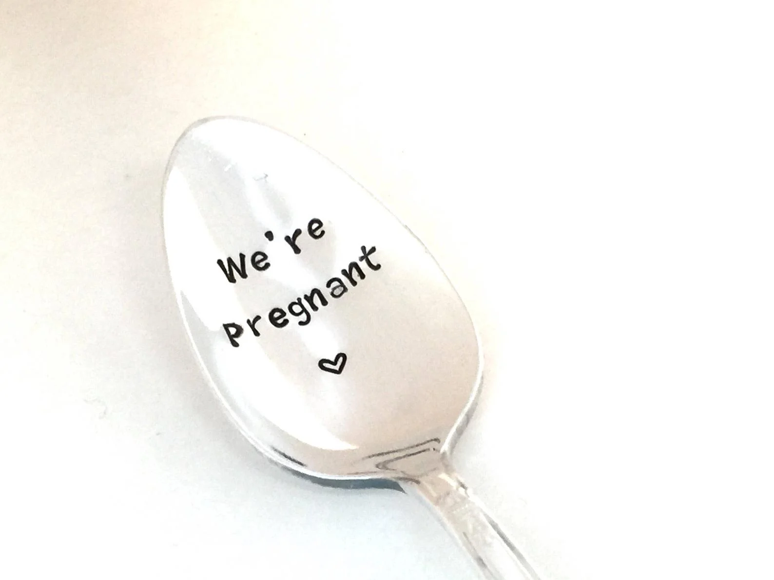 Spoon that says “we’re pregnant” to be used as a pregnancy announcement to husband.