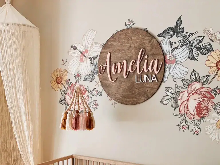 Baby girl nursery decorated with baby name sign.
