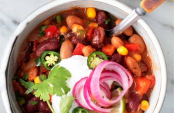 Vegetarian chili with beans corn and peppers topped with sour cream