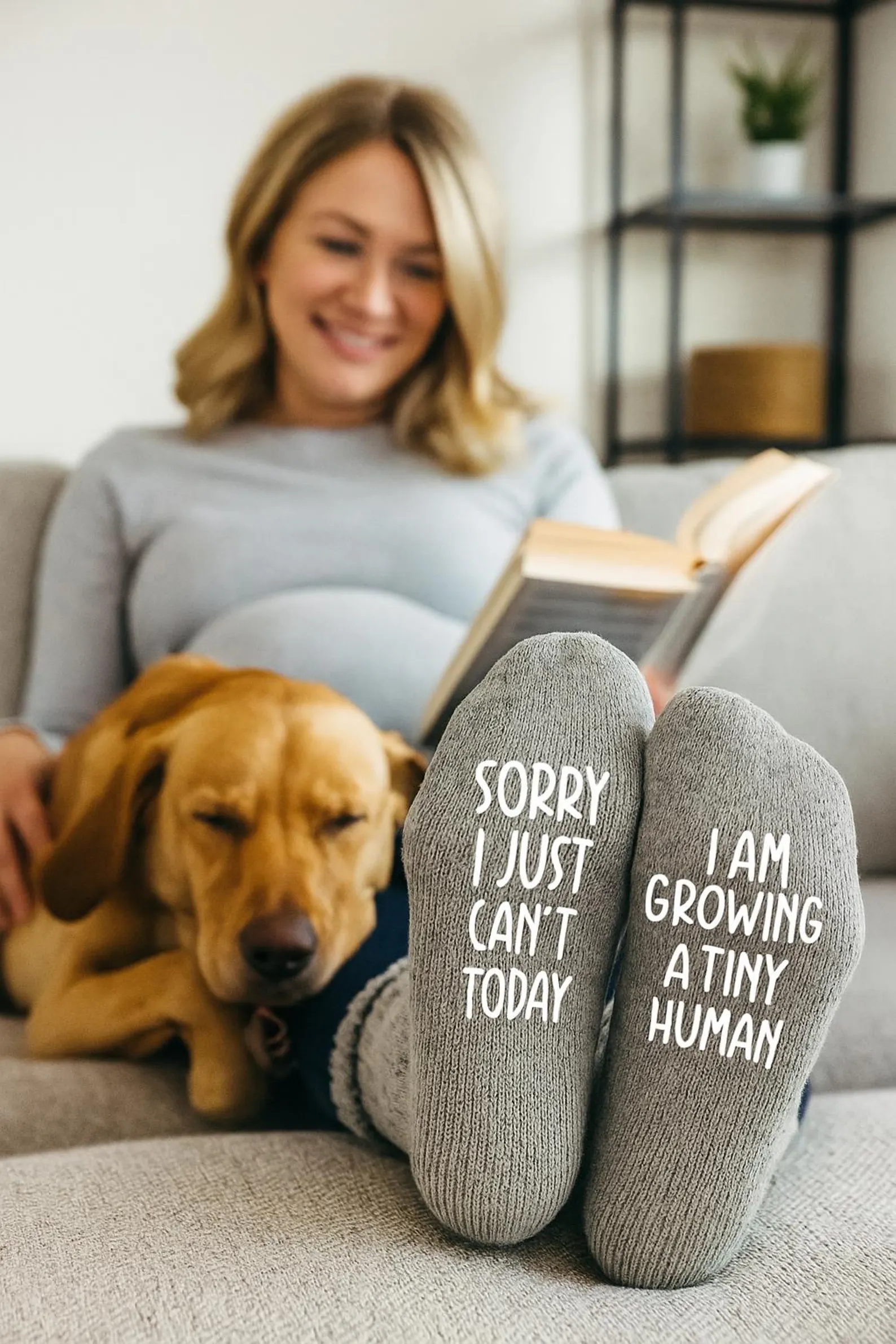 A women on a couch wearing pregnancy announcement socks