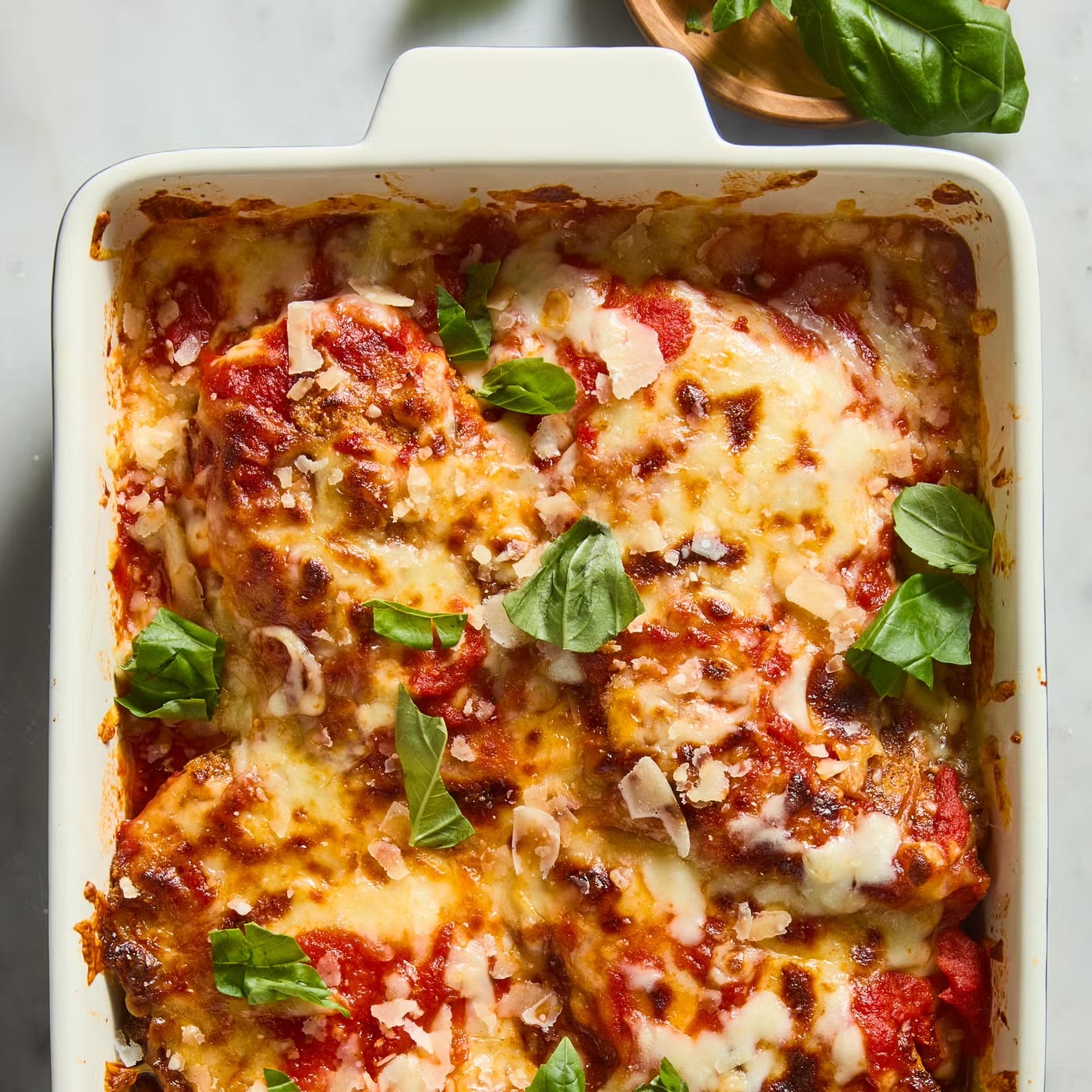Keto chicken parmesan baked with marinara sauce and melted cheese topped with fresh basil, gestational diabetes dinner idea.