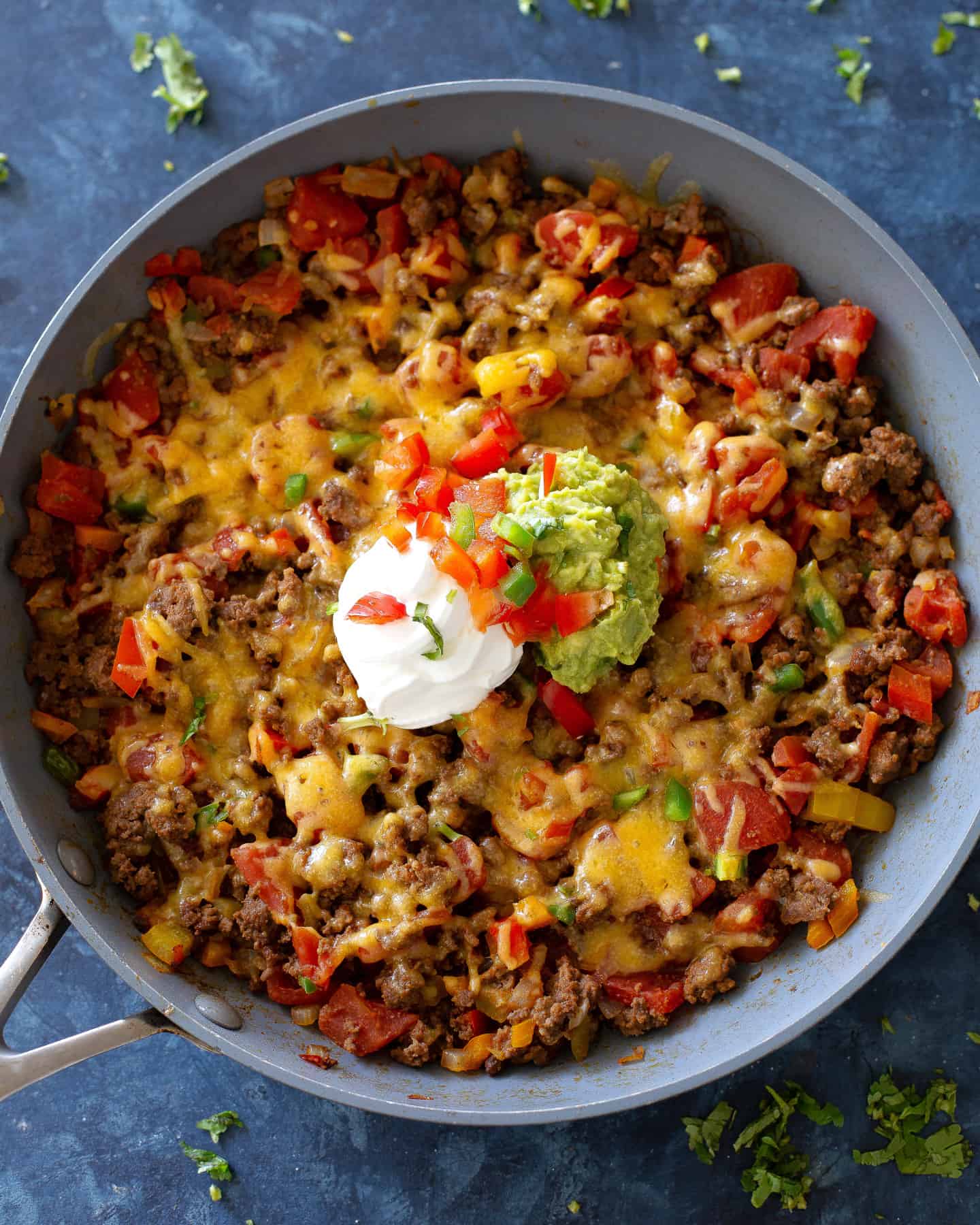 Low carb taco skillet with ground beef, bell peppers, melted cheese, and toppings, gestational diabetes dinner idea.