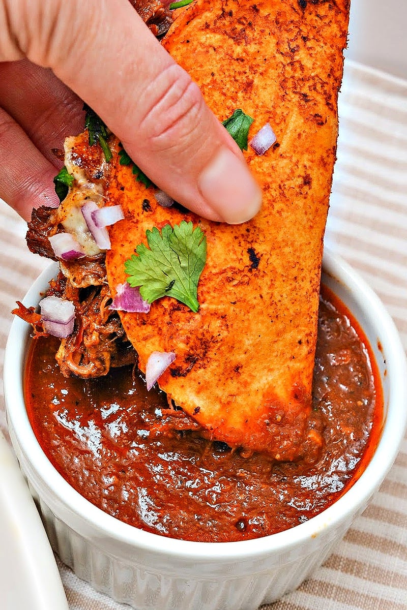 Crispy birria tacos filled with shredded beef and cheese served with rich dipping broth, healthy dinner for gestational diabetes.