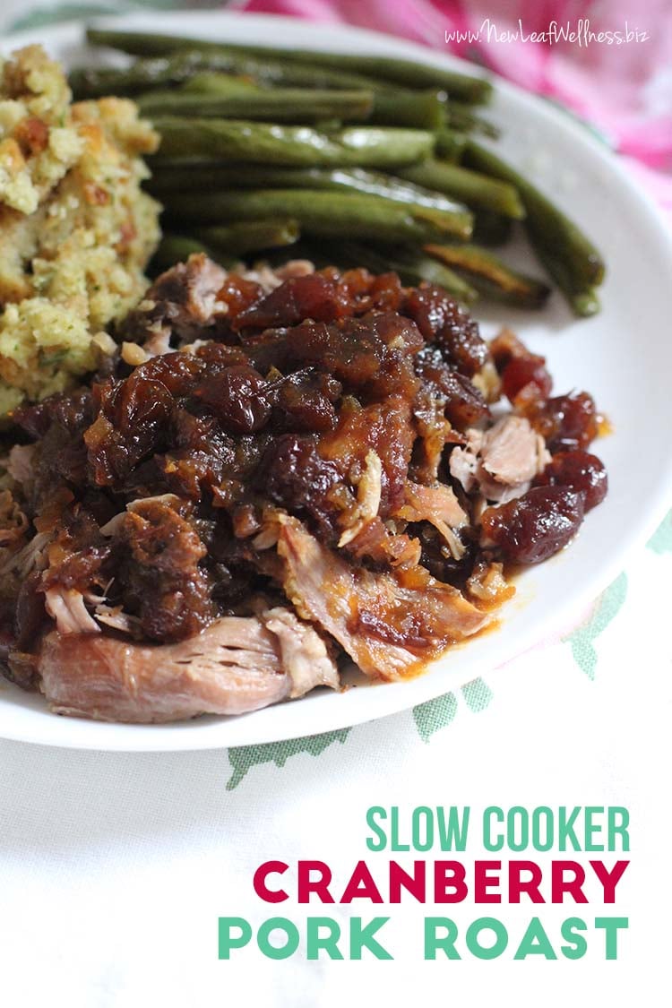 Slow cooker cranberry pork served with stuffing and green beans on a dinner plate.