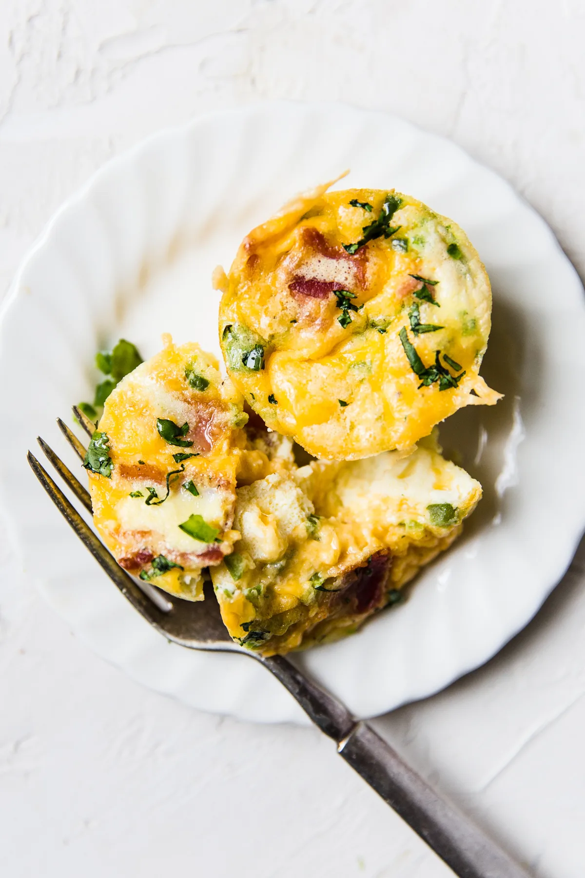 Easy gestational diabetes breakfast consisting of egg muffins with bacon, cheese, spinach, and peppers.